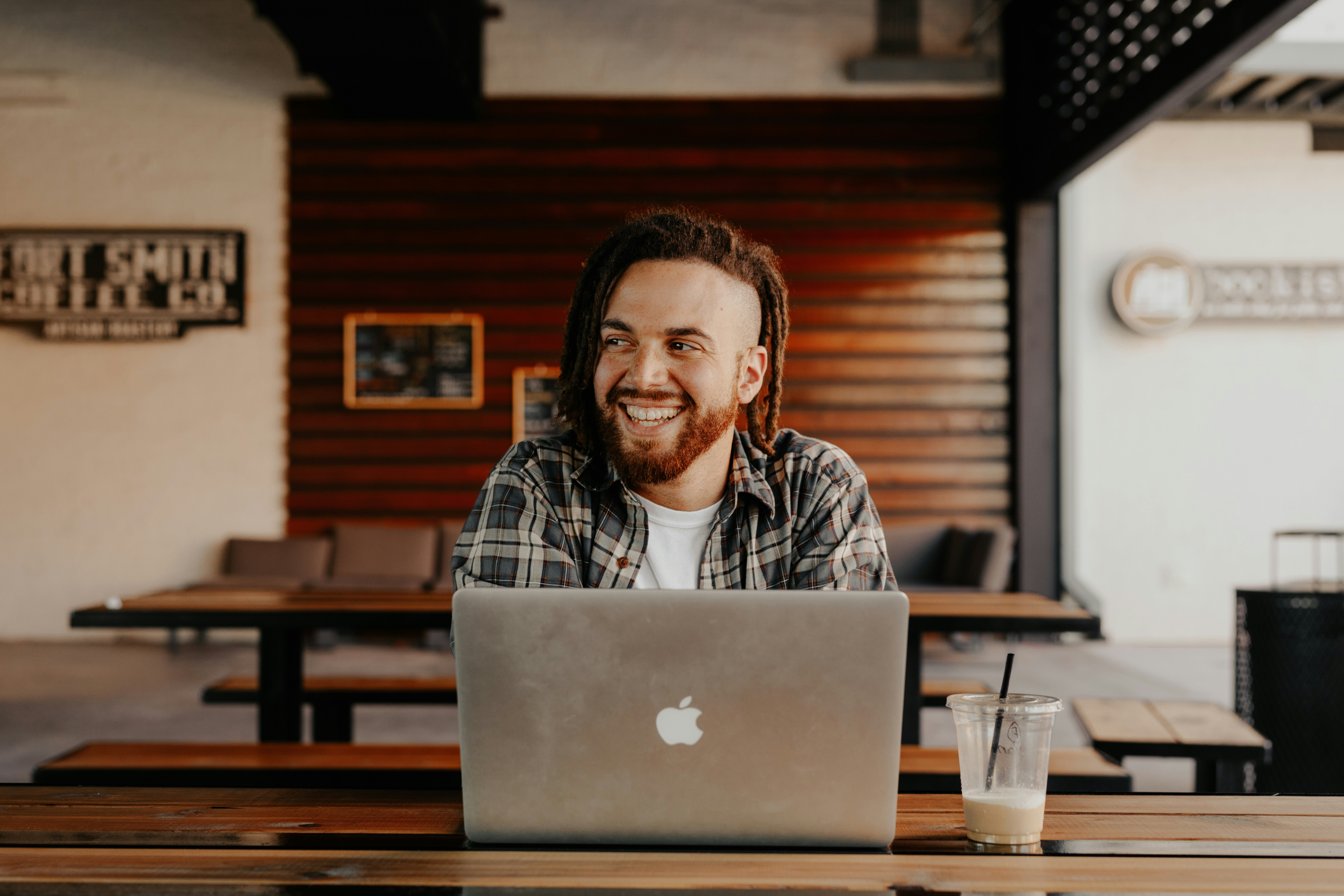 Man working on laptop at coffee shop